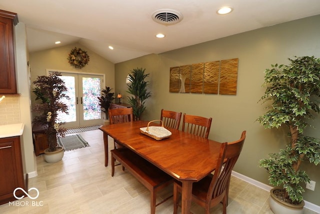 dining space with french doors, vaulted ceiling, baseboards, visible vents, and recessed lighting