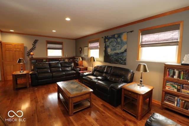 living room featuring wood-type flooring, crown molding, and recessed lighting
