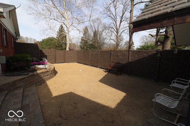 view of yard featuring a fenced backyard and a patio