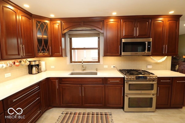 kitchen with light countertops, stainless steel appliances, and a sink