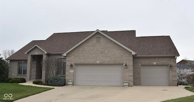 6087 Boulder Ct, Columbus, IN 47201 - view of front facade with concrete driveway, a garage, a shingled roof, and brick siding