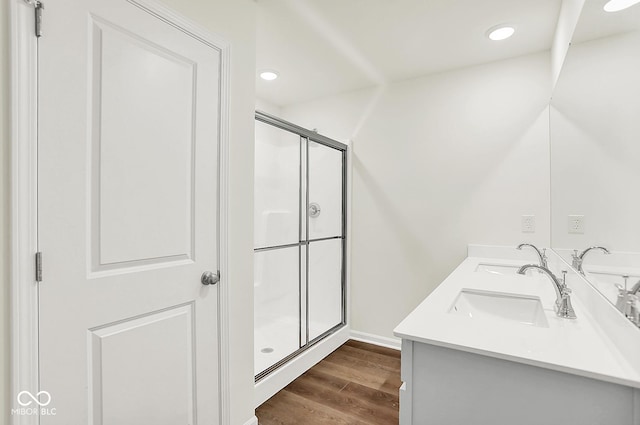 2764 Glade Ave, Plainfield, IN 46168 - bathroom featuring double vanity, a shower stall, wood finished floors, baseboards, and recessed lighting
