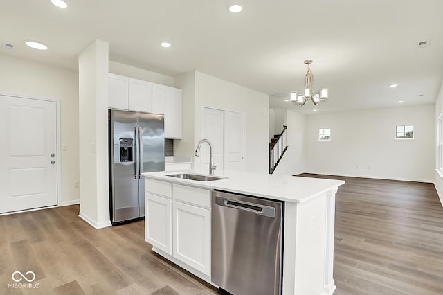 2764 Glade Ave, Plainfield, IN 46168 - kitchen with appliances with stainless steel finishes, a sink, white cabinets, a kitchen island with sink, and recessed lighting