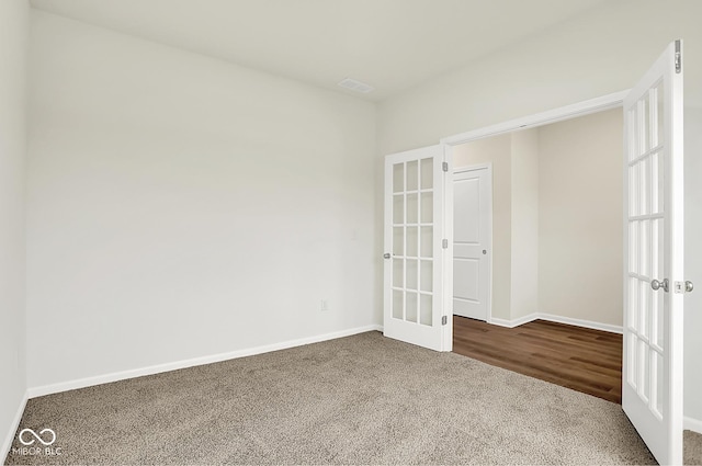 2764 Glade Ave, Plainfield, IN 46168 - unfurnished room featuring french doors, dark carpet, and baseboards