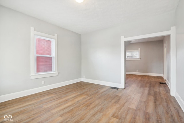 2114 N Dexter St, Indianapolis, IN 46202 - spare room featuring baseboards, visible vents, and light wood-style flooring