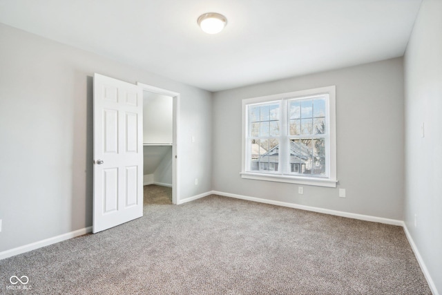 2114 N Dexter St, Indianapolis, IN 46202 - unfurnished bedroom with a spacious closet, baseboards, carpet floors, and a closet