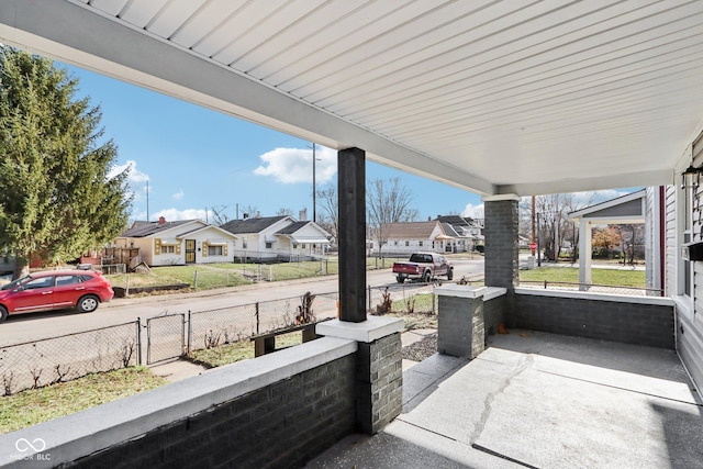2114 N Dexter St, Indianapolis, IN 46202 - view of patio with a residential view, covered porch, and fence