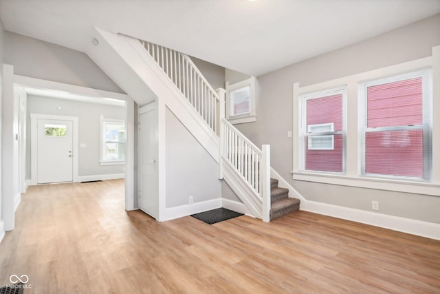 2114 N Dexter St, Indianapolis, IN 46202 - foyer entrance featuring light wood-type flooring, baseboards, stairway, and visible vents