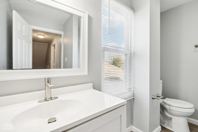 2114 N Dexter St, Indianapolis, IN 46202 - bathroom with baseboards, vanity, and toilet