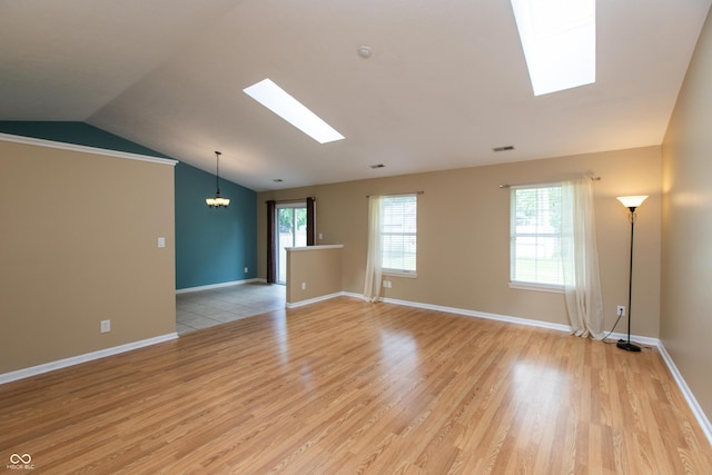 1579 Winding Creek Trl, Brownsburg, IN 46112 - unfurnished room featuring a skylight, lofted ceiling, light wood-style flooring, a chandelier, and plenty of natural light