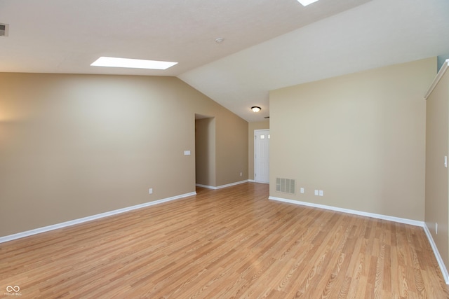 1579 Winding Creek Trl, Brownsburg, IN 46112 - empty room with light wood-style floors, a skylight, and lofted ceiling