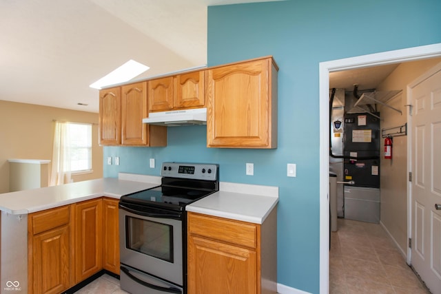 1579 Winding Creek Trl, Brownsburg, IN 46112 - kitchen with electric stove, under cabinet range hood, a peninsula, light countertops, and light tile patterned floors