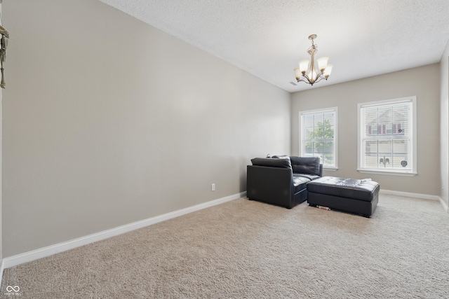621 Fireside Dr, Greenwood, IN 46143 - living area with a chandelier, carpet flooring, baseboards, and a textured ceiling