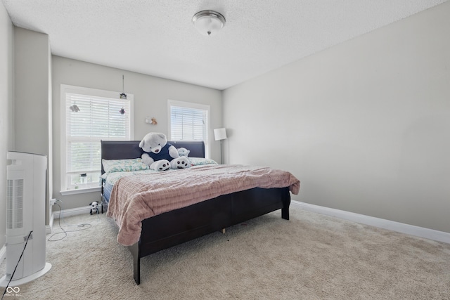 621 Fireside Dr, Greenwood, IN 46143 - bedroom featuring carpet flooring, a textured ceiling, baseboards, and heating unit