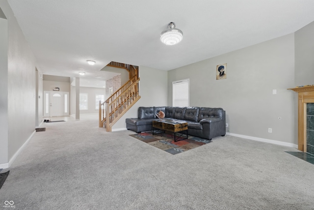 621 Fireside Dr, Greenwood, IN 46143 - carpeted living room with stairway, a fireplace, and baseboards