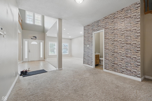 621 Fireside Dr, Greenwood, IN 46143 - carpeted entryway with healthy amount of natural light, baseboards, and a textured ceiling