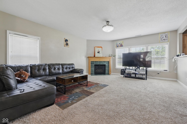 621 Fireside Dr, Greenwood, IN 46143 - living area featuring carpet, a tile fireplace, a textured ceiling, and baseboards