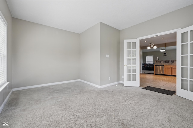 621 Fireside Dr, Greenwood, IN 46143 - unfurnished room featuring french doors, light carpet, plenty of natural light, and baseboards