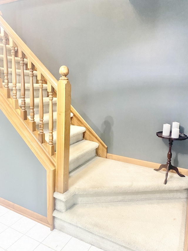 stairway with baseboards and carpet