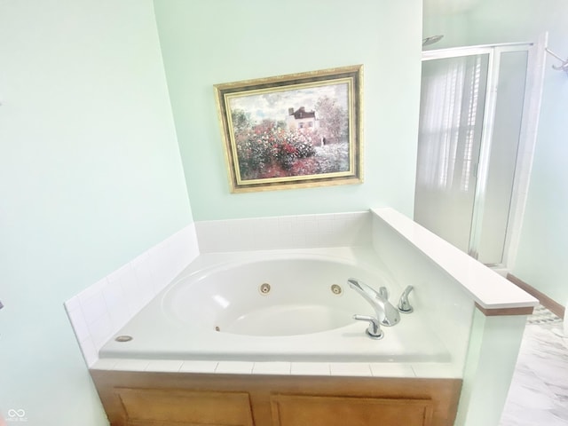 bathroom with a whirlpool tub and a stall shower