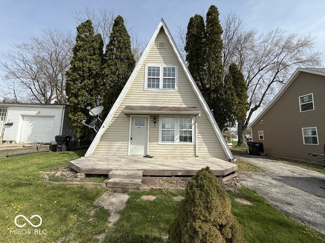 a-frame home featuring a front lawn