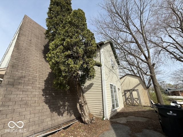 view of side of property with a storage unit and an outdoor structure