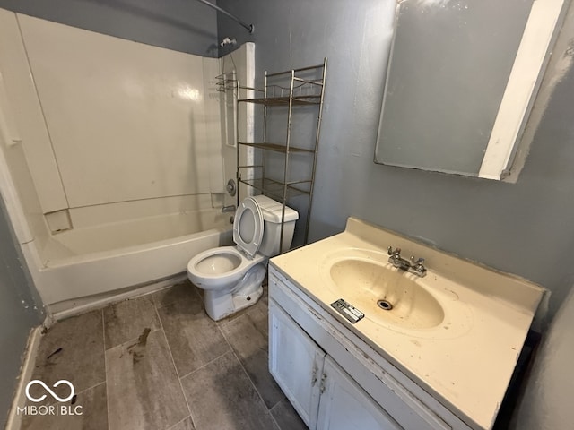bathroom with toilet, vanity, and bathtub / shower combination