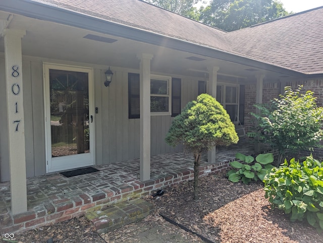 8017 Dogwood Ct, Plainfield, IN 46168 - entrance to property with a shingled roof and a porch