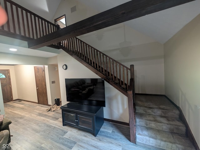 8017 Dogwood Ct, Plainfield, IN 46168 - stairway featuring high vaulted ceiling and wood finished floors
