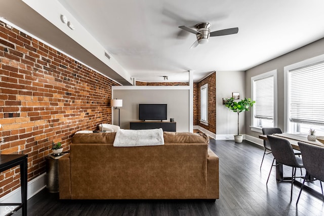 801 N Pennsylvania St Apt D, Indianapolis, IN 46204 - living room with brick wall, healthy amount of natural light, a ceiling fan, dark wood-style floors, and baseboards