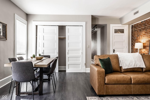 801 N Pennsylvania St Apt D, Indianapolis, IN 46204 - living room featuring baseboards and dark wood-style floors
