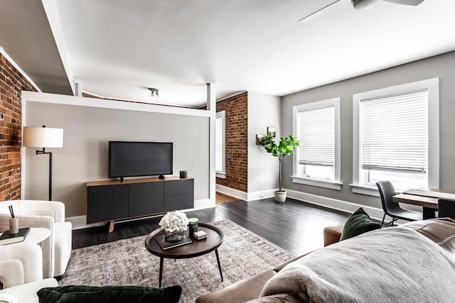 801 N Pennsylvania St Apt D, Indianapolis, IN 46204 - living area with brick wall, wood finished floors, baseboards, and ceiling fan
