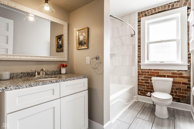 801 N Pennsylvania St Apt D, Indianapolis, IN 46204 - bathroom with baseboards, toilet, vanity, and tub / shower combination