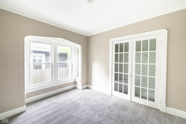 carpeted empty room featuring baseboards