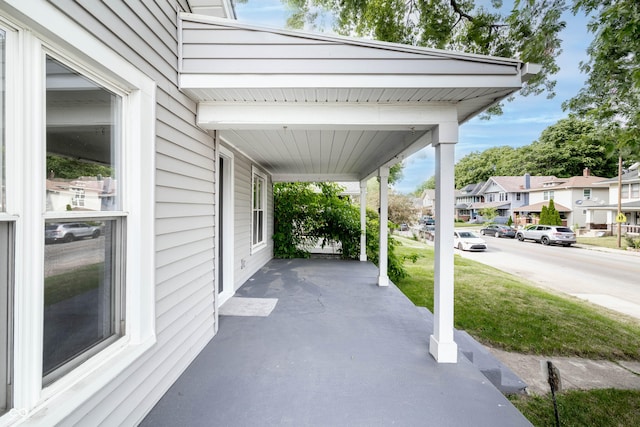 view of patio with covered porch and a residential view