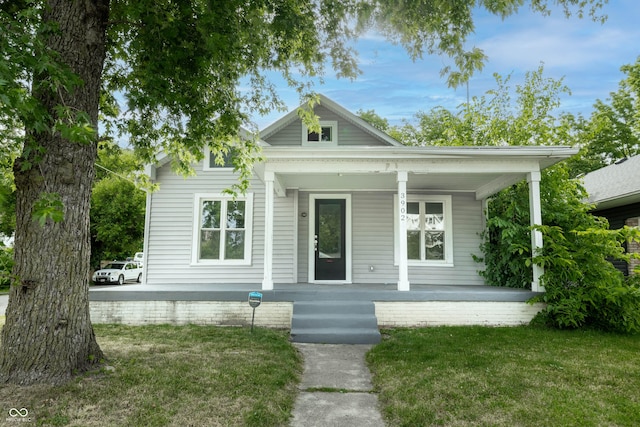 view of front of house with a front lawn and covered porch