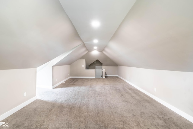 bonus room with lofted ceiling, baseboards, and carpet floors