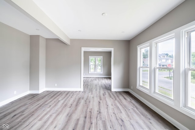 spare room with light wood-style flooring and baseboards