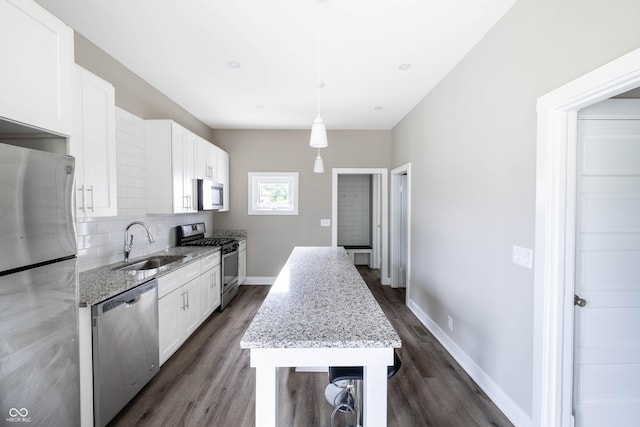 kitchen featuring white cabinetry, stainless steel appliances, dark wood-style floors, and a sink