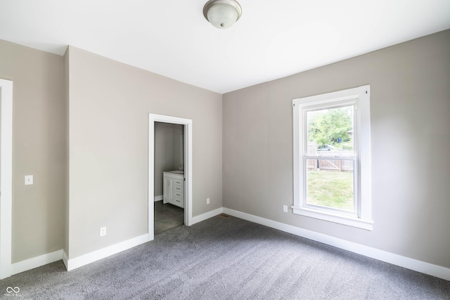 unfurnished bedroom featuring carpet and baseboards