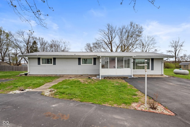 3335 W 400 N, Anderson, IN 46011 - ranch-style house featuring metal roof, a sunroom, and asphalt driveway