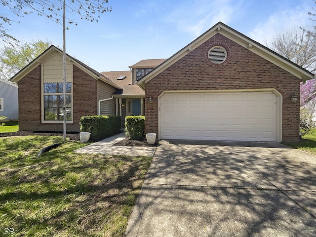 9162 Hadway Dr, Indianapolis, IN 46256 - view of front of home with an attached garage, brick siding, and driveway