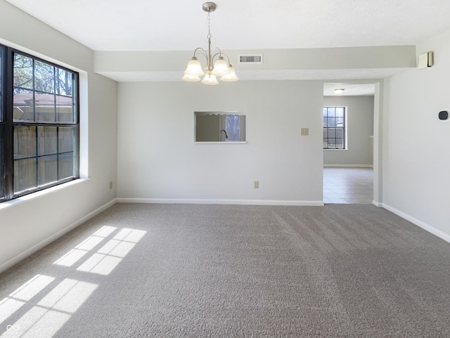 9162 Hadway Dr, Indianapolis, IN 46256 - carpeted spare room featuring baseboards, a chandelier, and visible vents