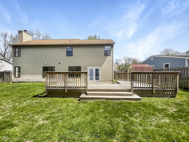 9162 Hadway Dr, Indianapolis, IN 46256 - rear view of property with a chimney, a deck, a fenced backyard, a yard, and a storage unit