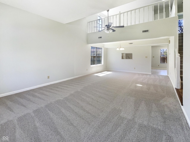 9162 Hadway Dr, Indianapolis, IN 46256 - unfurnished living room featuring ceiling fan, baseboards, a healthy amount of sunlight, and carpet