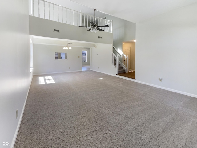 9162 Hadway Dr, Indianapolis, IN 46256 - unfurnished living room featuring baseboards, stairs, carpet floors, and ceiling fan with notable chandelier