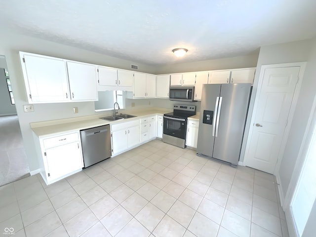 9162 Hadway Dr, Indianapolis, IN 46256 - kitchen featuring appliances with stainless steel finishes, a sink, light countertops, white cabinets, and light tile patterned floors