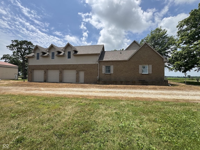 2365 E 850 N, Lebanon, IN 46052 - view of front of home with driveway, brick siding, a garage, and a front lawn