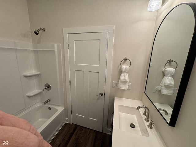 full bath featuring shower / washtub combination, wood finished floors, and vanity