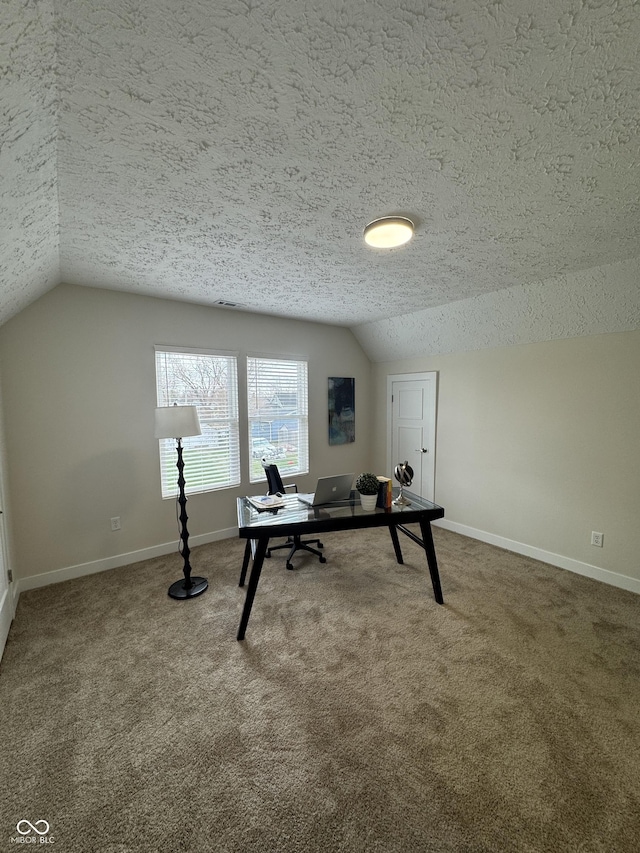 carpeted office featuring lofted ceiling, baseboards, and a textured ceiling